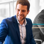 banner – business law a businessman talks with another professional at a conference table