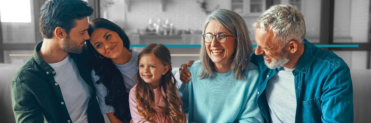 younger grandparents sitting on a couch with a young couple and their little girl