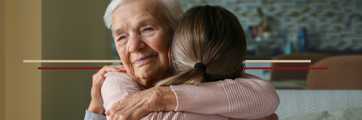 nov-banner-lng-term-care elderly woman hugging granddaughter looking off towards the distance